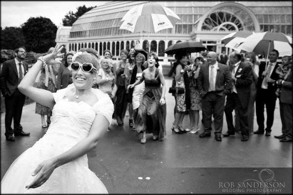bride throws her bouquet outside the palm house