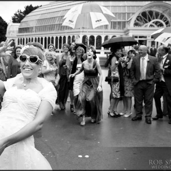 bride throws her bouquet outside the palm house