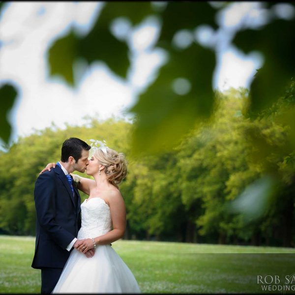 romantic picture of bride and groom kissing in Sefton Park