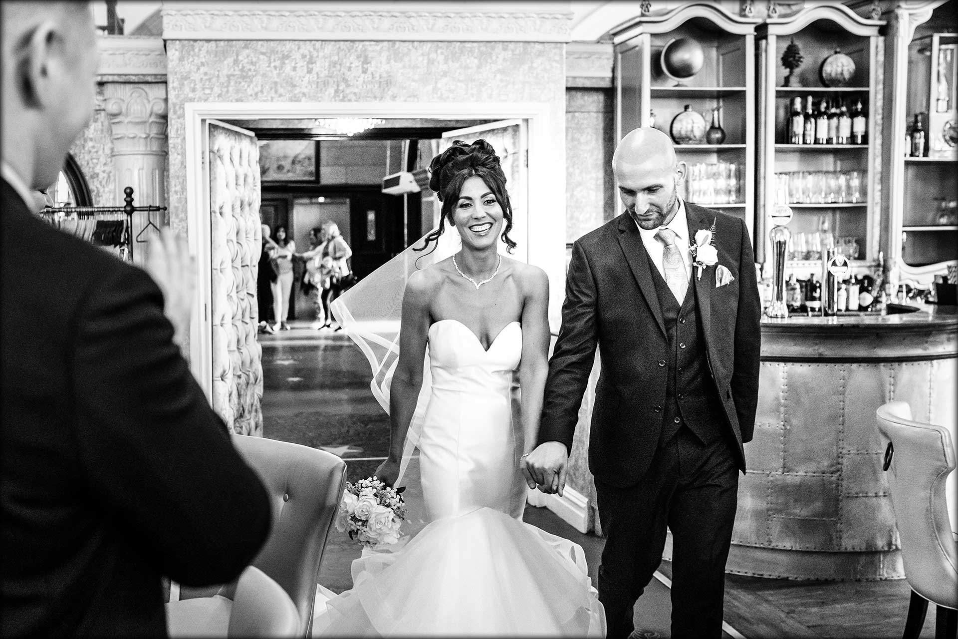 bride and groom enter the wedding breakfast